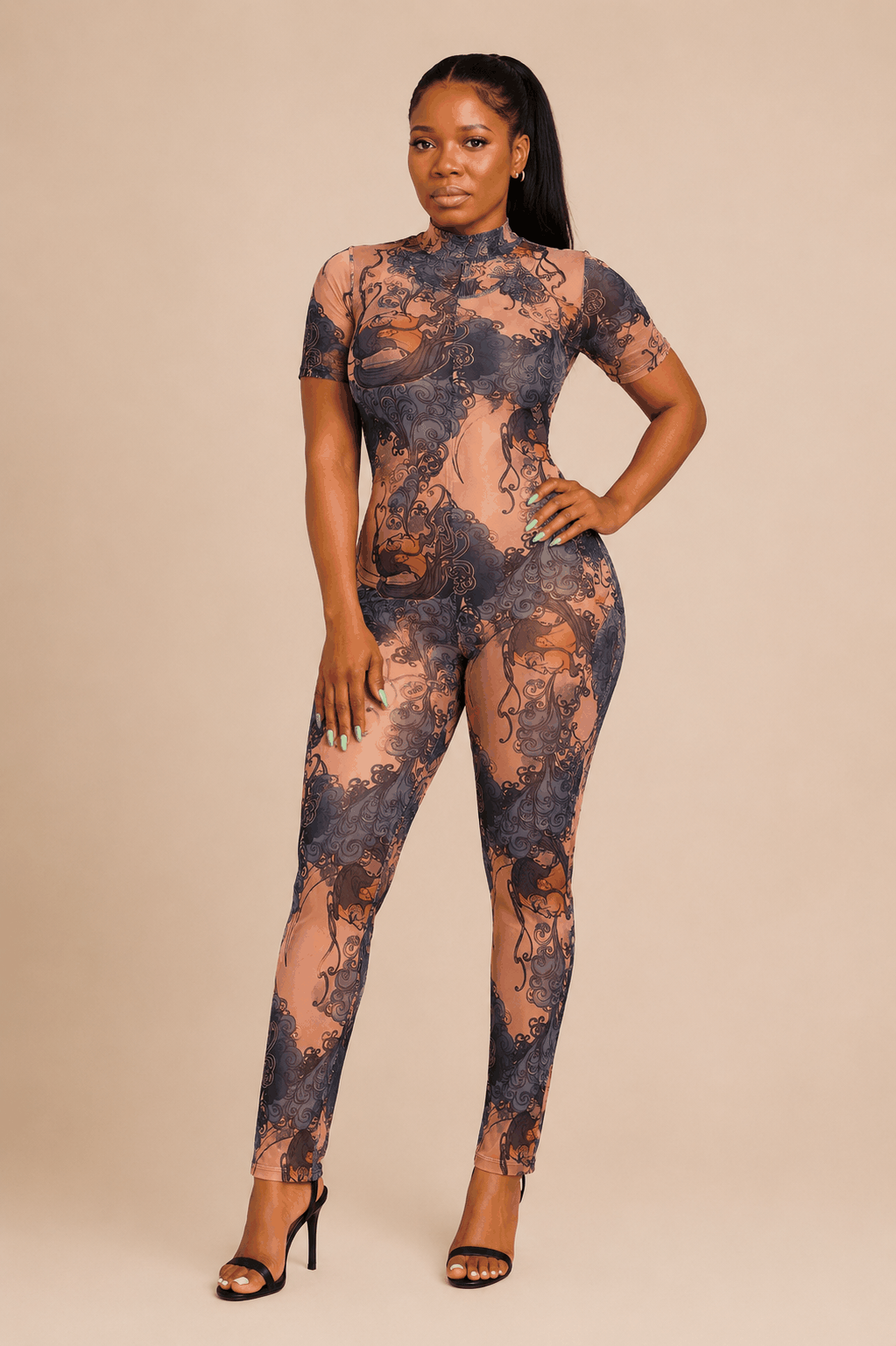 Woman wearing sheer baroque print open-back jumpsuit with fitted silhouette and high neckline