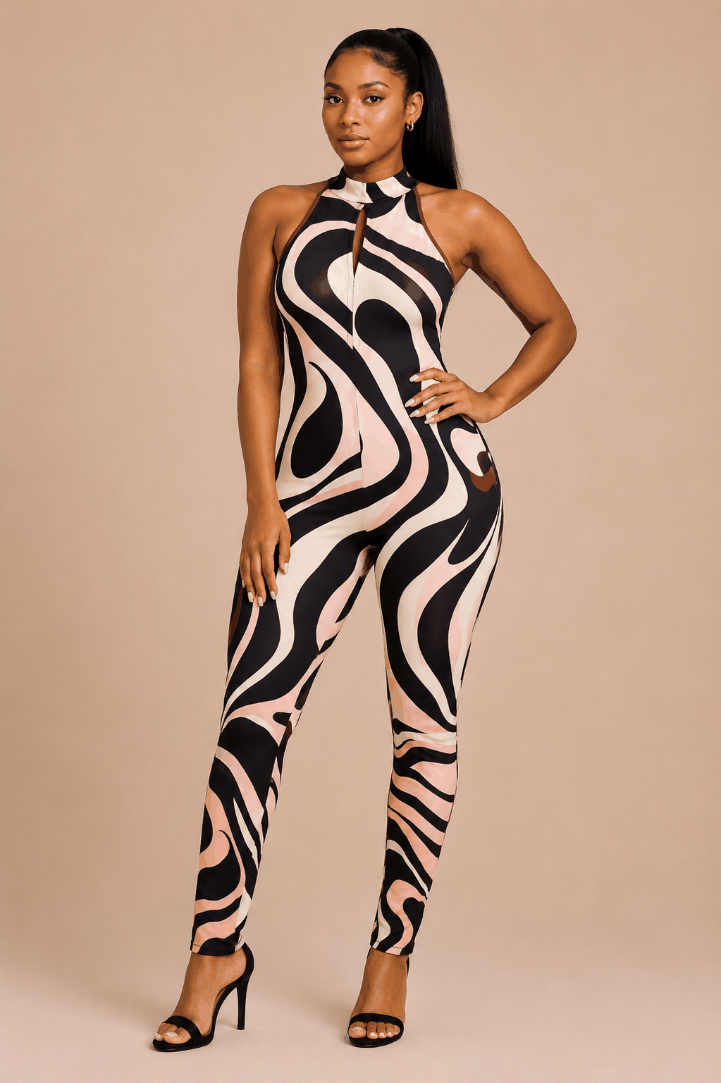 Woman wearing swirl print halter jumpsuit with fitted silhouette and keyhole detail