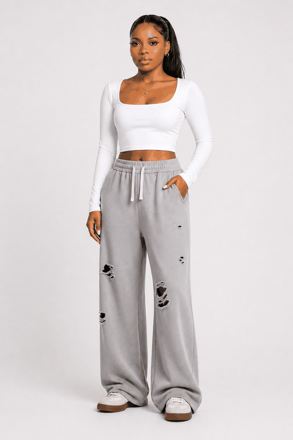 Distressed wide-leg drawstring sweatpants with elastic waistband and ripped detailing for casual streetwear style