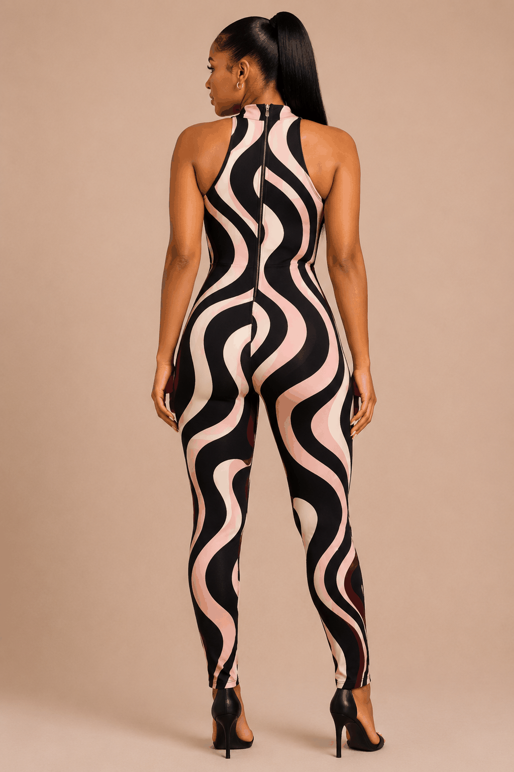 Woman wearing a swirl print halter jumpsuit with keyhole front and wave pattern