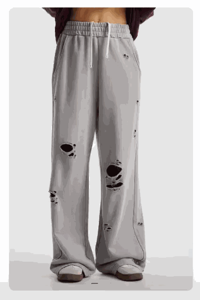 Distressed wide-leg drawstring sweatpants with elastic waistband and ripped details for casual comfort and street style