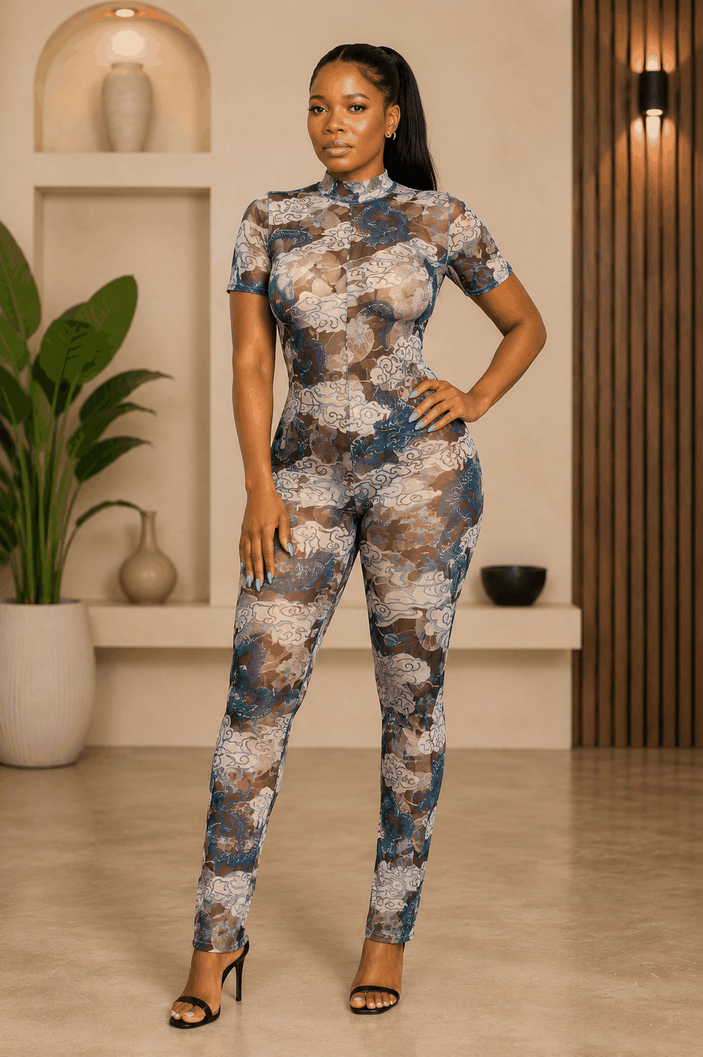 Blue Dragon Mesh Jumpsuit with sheer fabric and dragon cloud print, high neckline, short sleeves, and open-back detail.